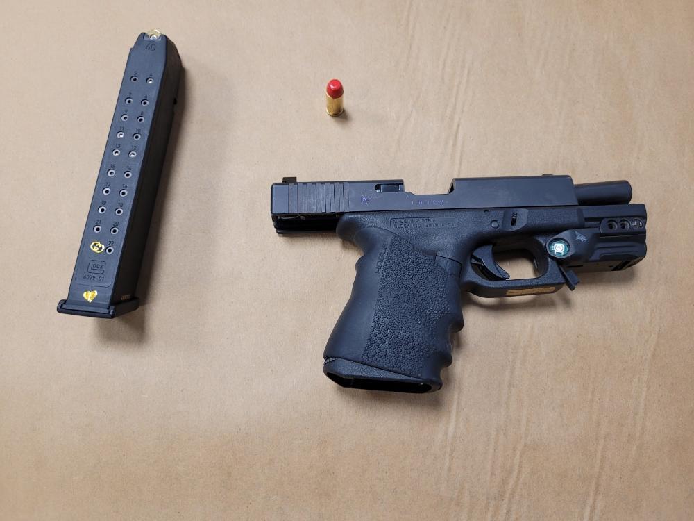 Police make two arrests after locating loaded handgun in vehicle